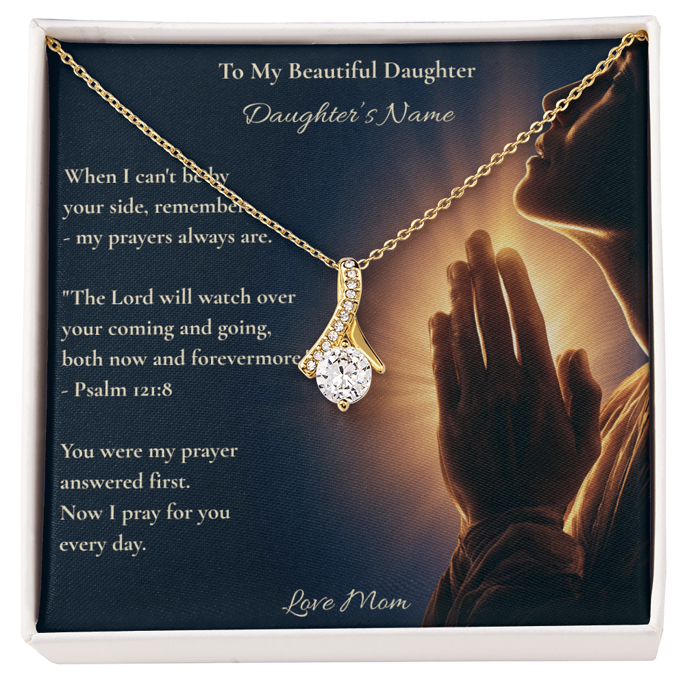 Hand holding a daughter message card and necklace with Psalm 121:8 outdoors on grass