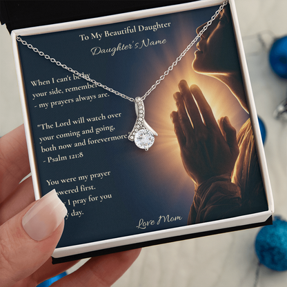 Hand holding a personalised Psalm 121:8 necklace card for a daughter from mom