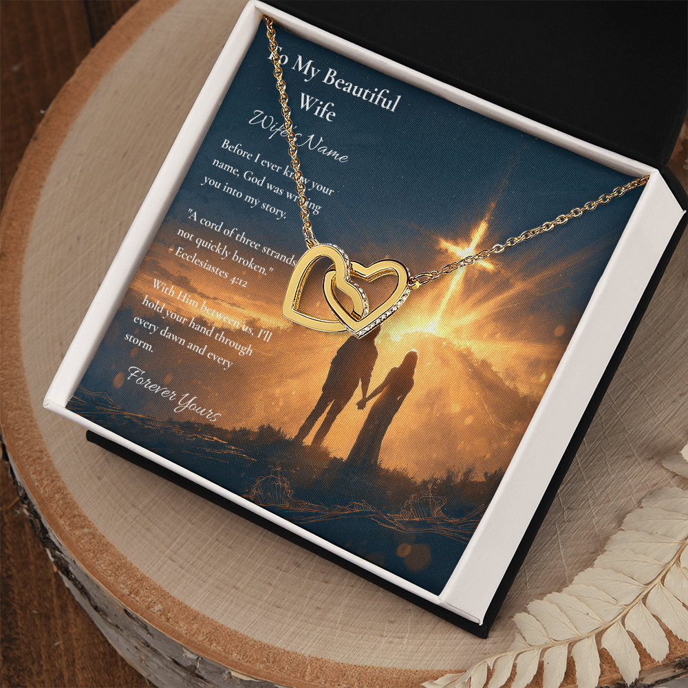 Interlocking hearts necklace and wife card with Ecclesiastes 4:12 in a gift box on wood