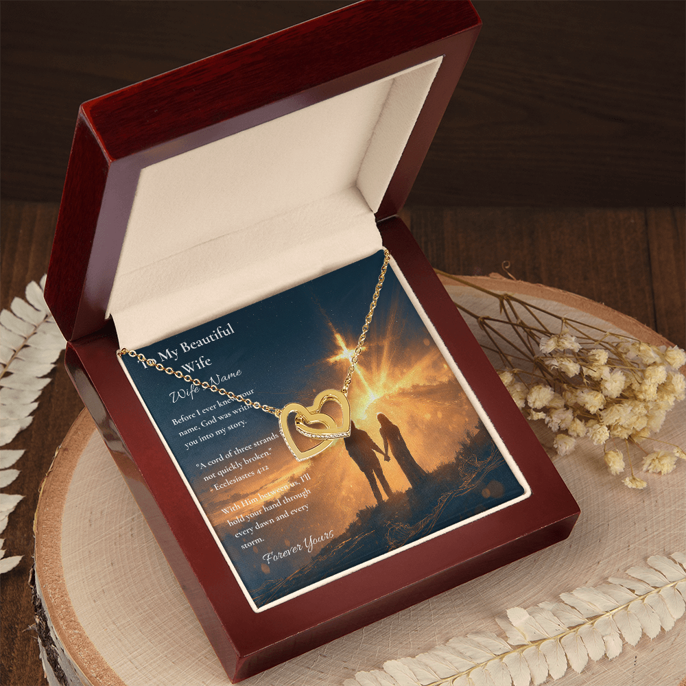 Two-tone hearts necklace and To My Beautiful Wife card in an open red box on wood