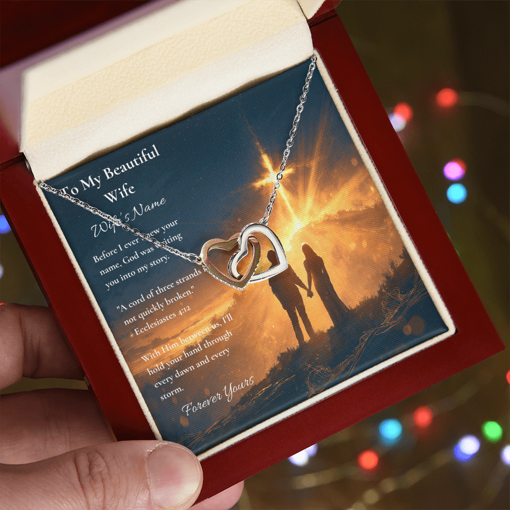 Hand holding an Interlocking Hearts necklace and wife card with Ecclesiastes 4:12