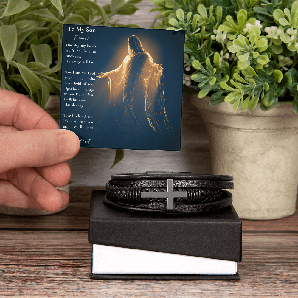 Hand holding a personalized Isaiah 41:13 son card beside a cross bracelet and a potted plant
