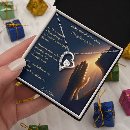 White gold Forever Love heart necklace on a To My Beautiful Daughter card, held above wrapped gifts