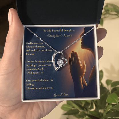 Hand holding a personalised heart necklace card for a daughter with Philippians 4:6, a Christian gift from mom