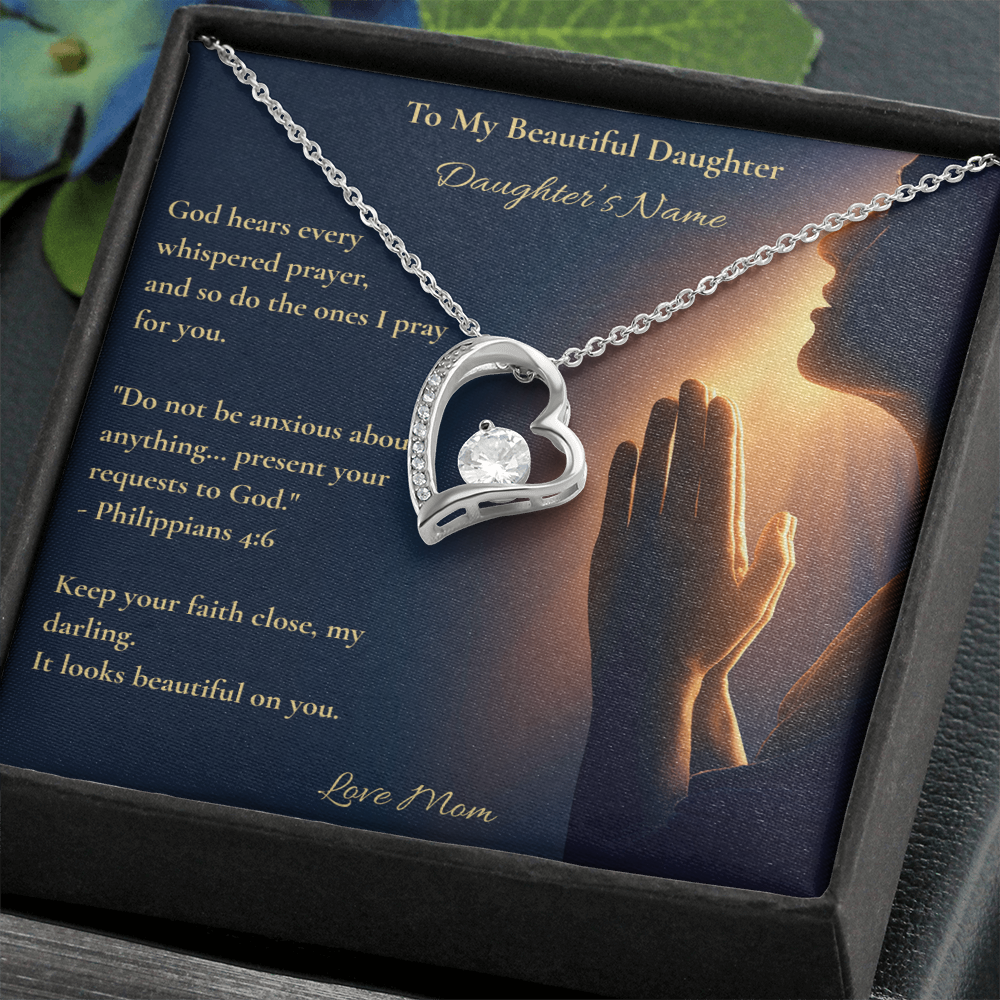 Silver heart pendant necklace and daughter message card displayed in a black gift box with foliage